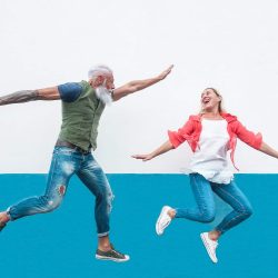 Happy seniors crazy couple jumping together outdoor